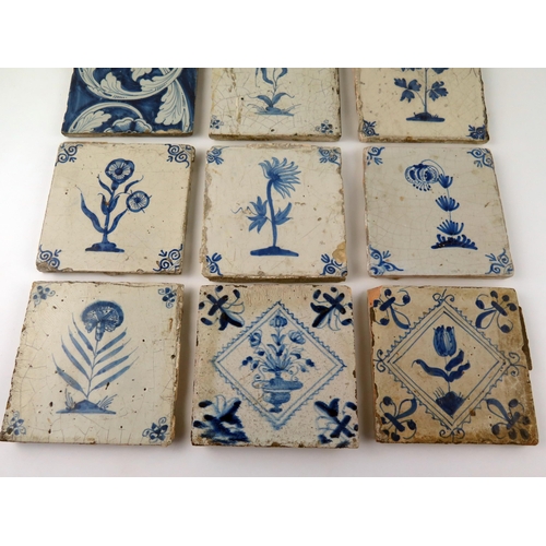 1343 - Nine assorted Dutch Delft tiles each decorated with a flower or floral sprays, each 13 x 13cm.