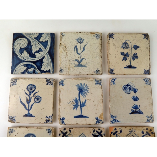 1343 - Nine assorted Dutch Delft tiles each decorated with a flower or floral sprays, each 13 x 13cm.