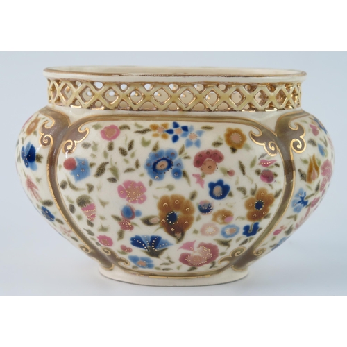 1355 - A Zsolnay Pecs oval posy vase, with pierced rim, the body of lobed oval form, decorated with floral ... 