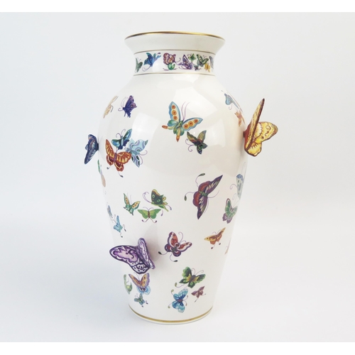 1357 - A Franklin Mint porcelain vase, decorated with painted and applied butterflies, 30cm high.