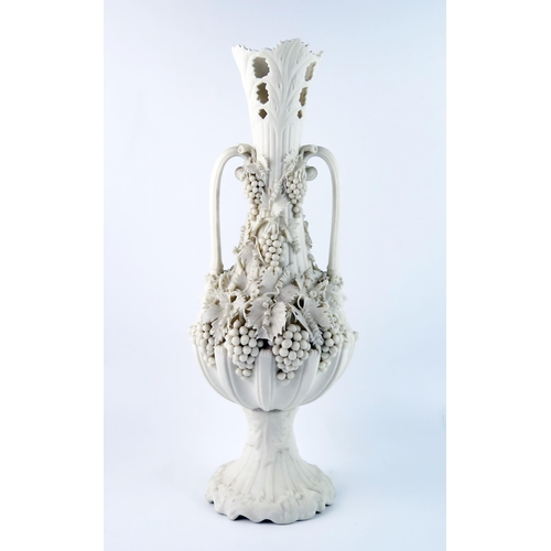 1358 - A Parian Bacchanalian vase of slender ovoid form with pierced neck and decorated all over with vine ... 