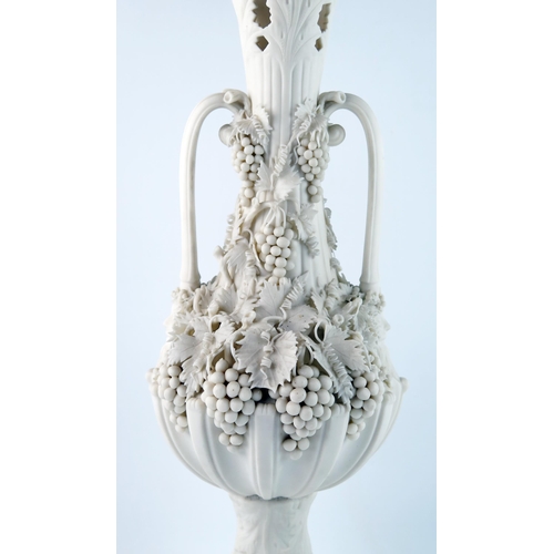 1358 - A Parian Bacchanalian vase of slender ovoid form with pierced neck and decorated all over with vine ... 