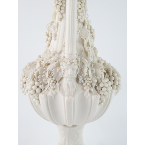 1358 - A Parian Bacchanalian vase of slender ovoid form with pierced neck and decorated all over with vine ... 