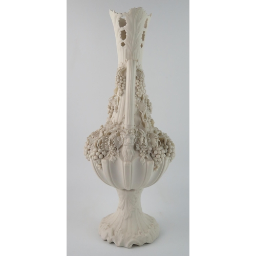 1358 - A Parian Bacchanalian vase of slender ovoid form with pierced neck and decorated all over with vine ... 