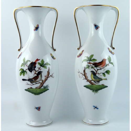 1399 - A pair of Herend porcelain twin handled vases of ovoid form with flared rims, with hand painted deco... 