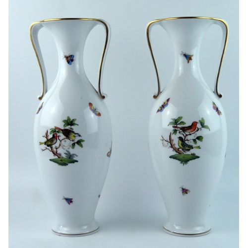 1399 - A pair of Herend porcelain twin handled vases of ovoid form with flared rims, with hand painted deco... 