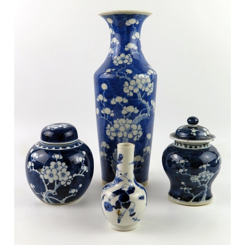 1414 - A Chinese blue and white vase with all over prunus decoration, 30cm high, a small bottle vase, ginge... 