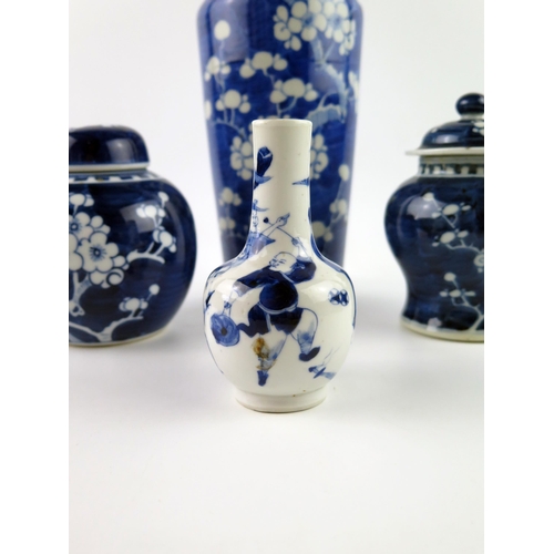 1414 - A Chinese blue and white vase with all over prunus decoration, 30cm high, a small bottle vase, ginge... 