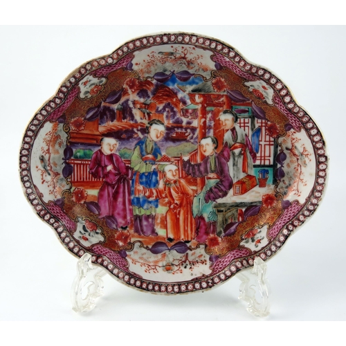 1417 - A 19th century Chinese dish of cartouche-shaped outline, decorated in enamels with figures in a gard... 