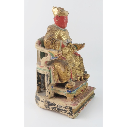 1420 - A late 19th century polychrome carved wooden figure of a seated emperor, with gilded decoration, 30c... 