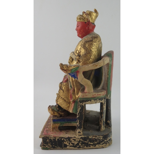 1420 - A late 19th century polychrome carved wooden figure of a seated emperor, with gilded decoration, 30c... 