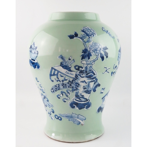 1421 - A Chinese vase of ovoid form, with blue and white auspicious objects to a green celadon ground, 37cm... 