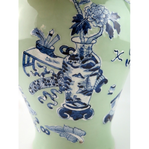 1421 - A Chinese vase of ovoid form, with blue and white auspicious objects to a green celadon ground, 37cm... 