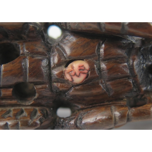 1428 - A Japanese carved boxwood netsuke in the form of a locust,  signed, 7cm long.