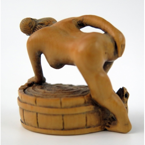 1429 - A Japanese carved Boxwood erotic netsuke of a female taking a bath, 4cm wide.