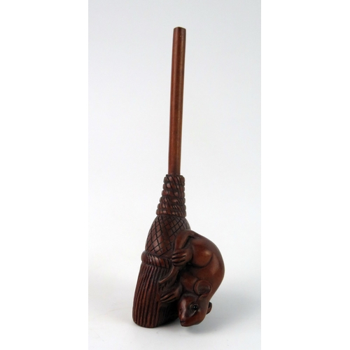 1430 - A Japanese carved boxwood netsuke of a rat on a broom, unsigned, 9cm long.