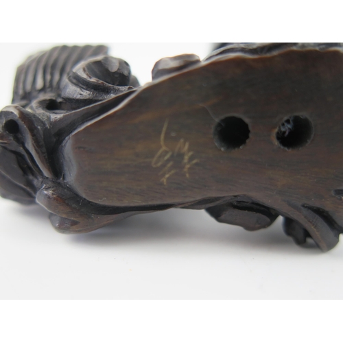 1432 - A Japanese carved and stained hardwood netsuke in the form of two leaping carp, unsigned, 5cm wide.