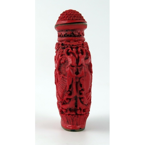 1433 - A Chinese faux cinnabar lacquer scent bottle, of moon-shaped outline decorated with figures in a pag... 