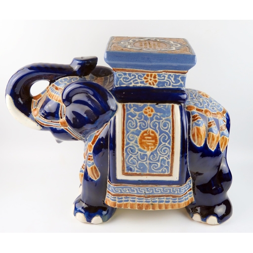 1437B - A large modern Chinese pottery jardinière stand in the form of elephant, with polychrome decoration,... 