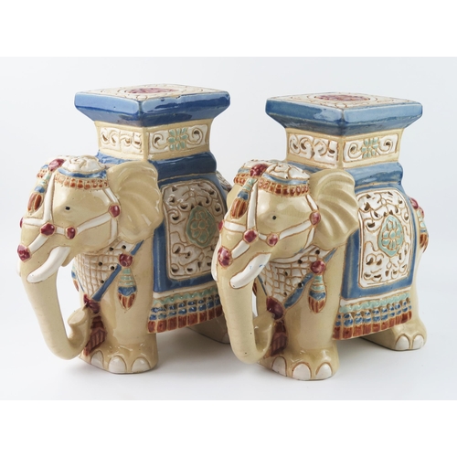 1438 - A pair of modern Chinese pottery jardinière stands in the form of elephants, with polychrome decorat... 