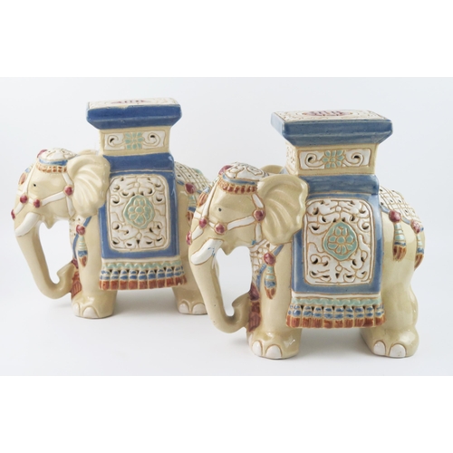 1438 - A pair of modern Chinese pottery jardinière stands in the form of elephants, with polychrome decorat... 