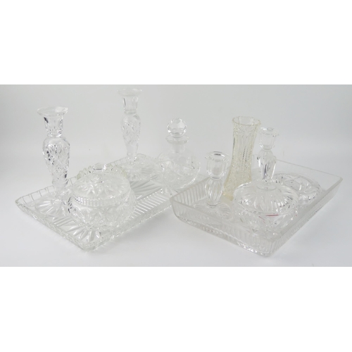 1489 - A clear glass dressing table set, includes candlesticks, tray, scent bottle, jar and cover, together... 