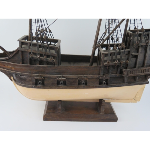 1550 - A wooden model of a two mast galleon, with painted hull, eight cannons, partially rigged, 72cm long.