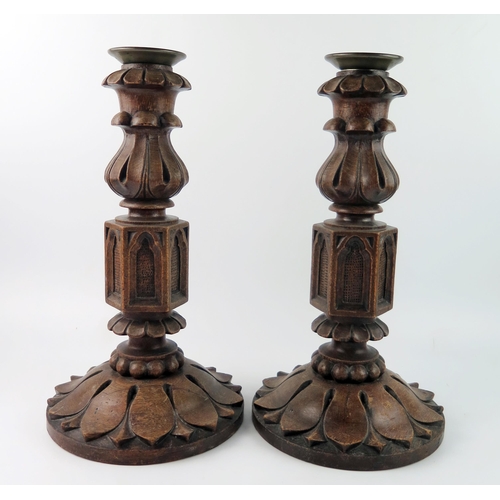 1568 - A pair of Victorian oak and bell metal candlesticks, with flared nozzles, foliate sconces on hexagon... 