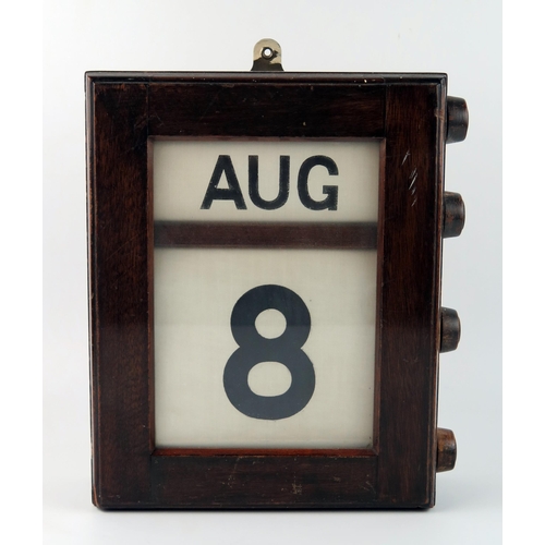 1569 - A mahogany cased wall perpetual calendar, with month and date panels, 29cm high.