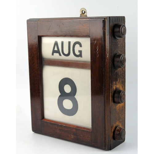 1569 - A mahogany cased wall perpetual calendar, with month and date panels, 29cm high.