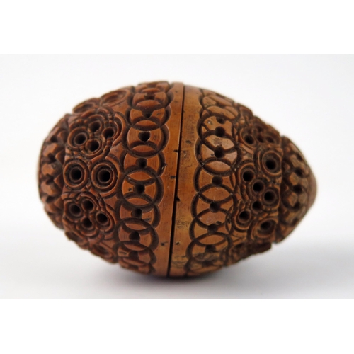 1575 - A carved Coquilla, with banded geometric decoration, 4.5cm long.