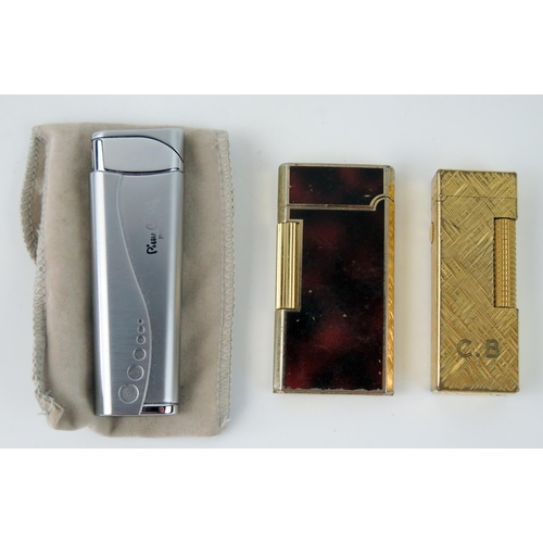 1582 - A Dunhill 'Rollagas' lighter with engine turned decoration, a Pierre Cardin cigarette lighter and a ... 