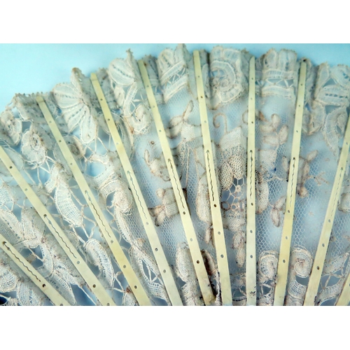 1634 - An Edwardian fan with lace work leaf mounted on mother-of-pearl sticks and guards, 19cm long.