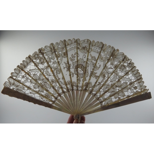 1634 - An Edwardian fan with lace work leaf mounted on mother-of-pearl sticks and guards, 19cm long.