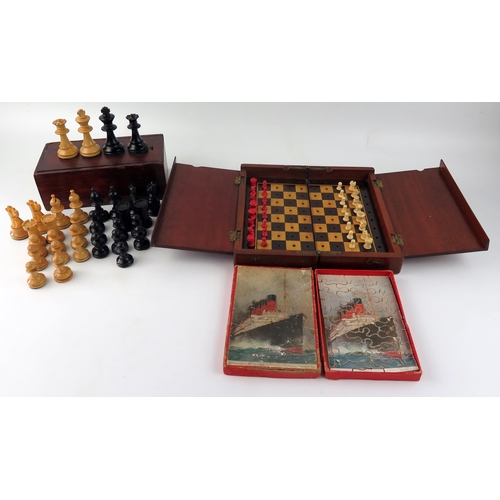 1652 - A travelling chess set, with natural and stained red bone chess pieces contained in a mahogany foldi... 