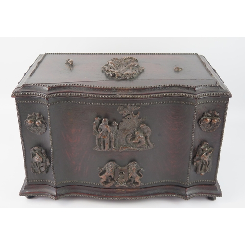 1655 - A continental oak writing box of serpentine outline, , the double hinged lid enclosing an arrangemen... 