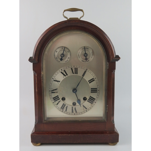 1659 - A mahogany cased director's style bracket clock, with arched silvered Roman dial with regulation and... 