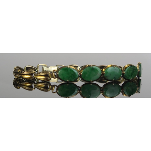 166 - A Jadeite Bracelet set with five 10.5x7mm oval cuts in an unmarked gold setting, c. 6.5