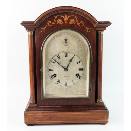 1660 - Collis & Russell, Ipswich, a mahogany and inlaid mantel clock of arched outline, with 14cm arched si... 