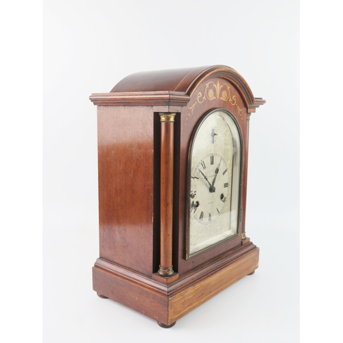 1660 - Collis & Russell, Ipswich, a mahogany and inlaid mantel clock of arched outline, with 14cm arched si... 