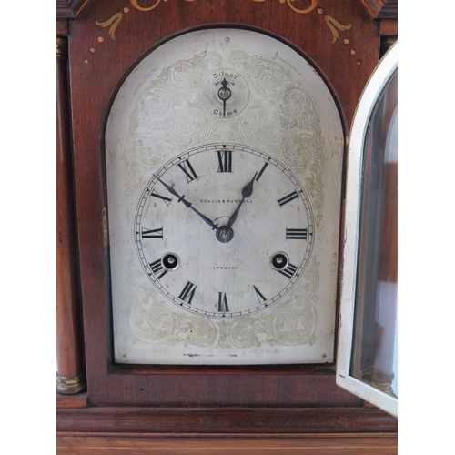 1660 - Collis & Russell, Ipswich, a mahogany and inlaid mantel clock of arched outline, with 14cm arched si... 