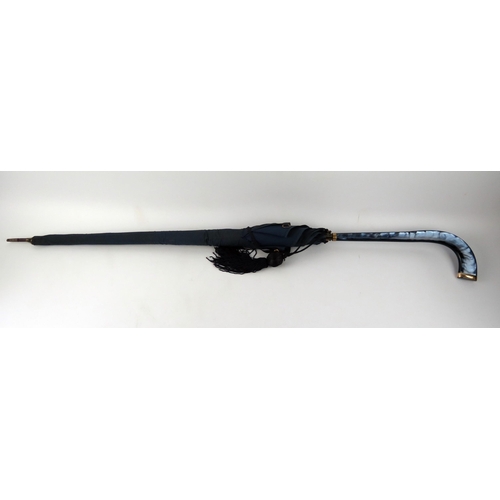 1676 - A lady's umbrella, with blue variegated plastic and 9ct gold mounted handle, 86cm long.