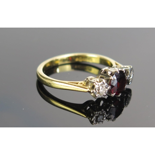 177 - An 18ct Gold, Garnet and White Sapphire Three Stone Ring, size J.5, 3.2g