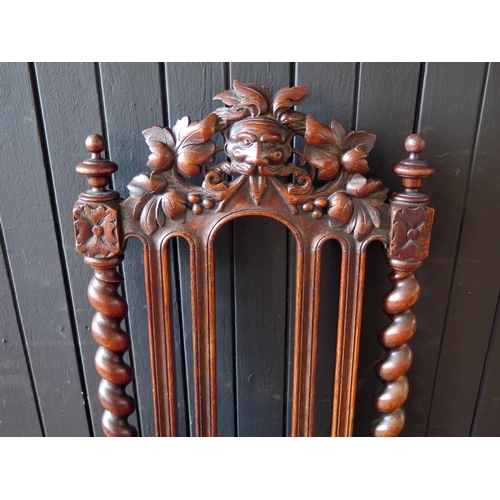 1779 - A Victorian oak hall chair in the Jacobean style, with arched carved top rail spiral twist back with... 