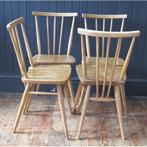 1784 - A set of four 1950's Ercol blonde stick-back chairs, with solid seats and turned legs.