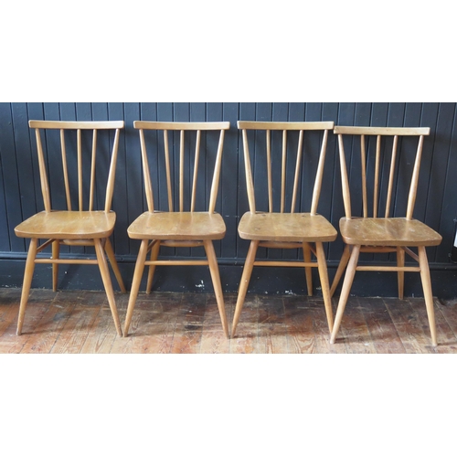 1784 - A set of four 1950's Ercol blonde stick-back chairs, with solid seats and turned legs.