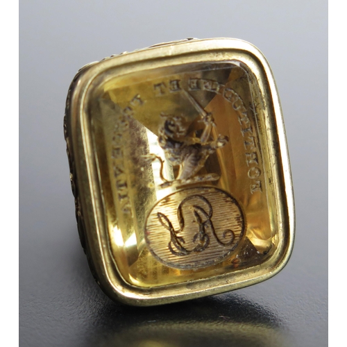23 - A Georgian Gilt Metal Fob Seal, the citrine? matrix engraved with a half length lion bearing a sword... 