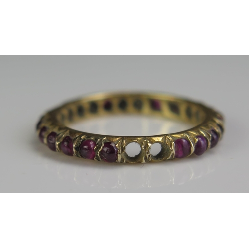 69 - A 19th Century Cabochon Garnet Eternity Ring in an unmarked high carat gold setting, 3mm wide, size ... 