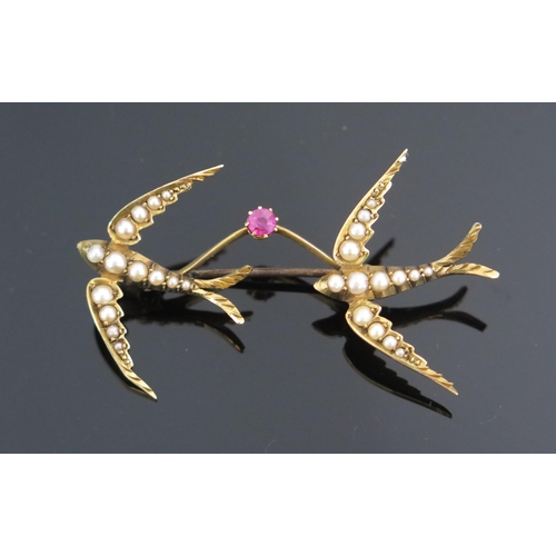 79 - A Twin Swallow Brooch linked by a pink spinel and mounted with untested pearls in an unmarked high c... 