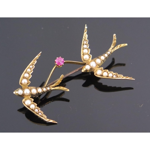 79 - A Twin Swallow Brooch linked by a pink spinel and mounted with untested pearls in an unmarked high c... 